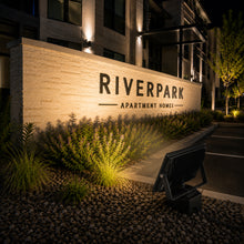Installed 100 watt outdoor LED flood light providing bright illumination for commercial and security applications