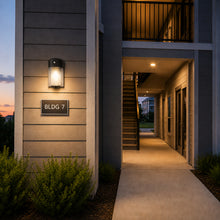 Installed 26 watt mini LED wall pack providing exterior security and area lighting for commercial buildings