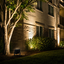 Installed 50 watt outdoor LED flood light illuminating landscaping signage building exteriors and security areas