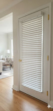 White door with blinds in a room with wooden flooring and a visible living area.