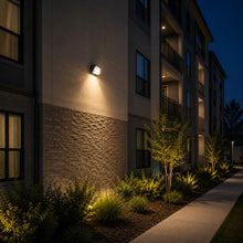 LED wall pack light installed on a apartment complex providing outdoor security illumination