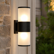 Installed up down LED wall sconce providing decorative architectural lighting on a building exterior